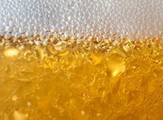 close up image of beer and beer bubbles